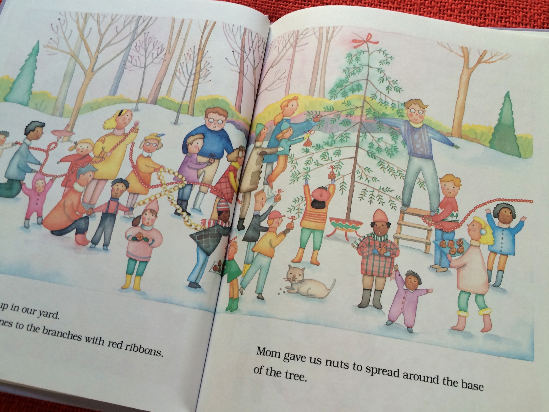 The After-Christmas Tree characters hang their goodies on the tree for the animals