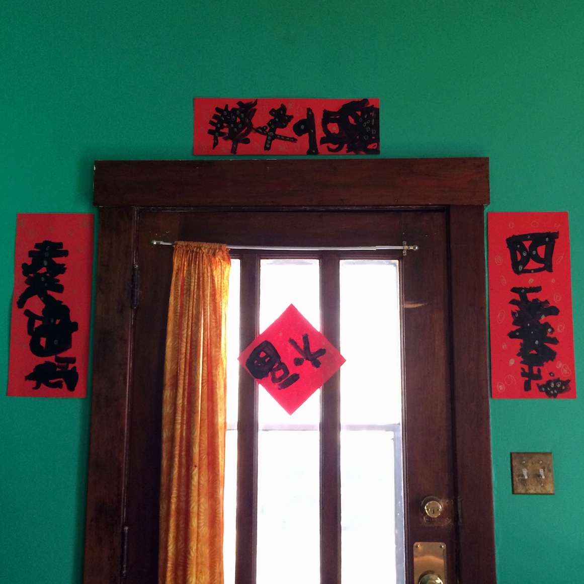 Hanging homemade good luck characters and spring couplets in honor of the Chinese Lunar New Year. This art activity for kids is an introduction to the ancient art of Chinese caliagraphy
